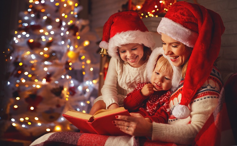 family reading a book at Christmas. holiday activities