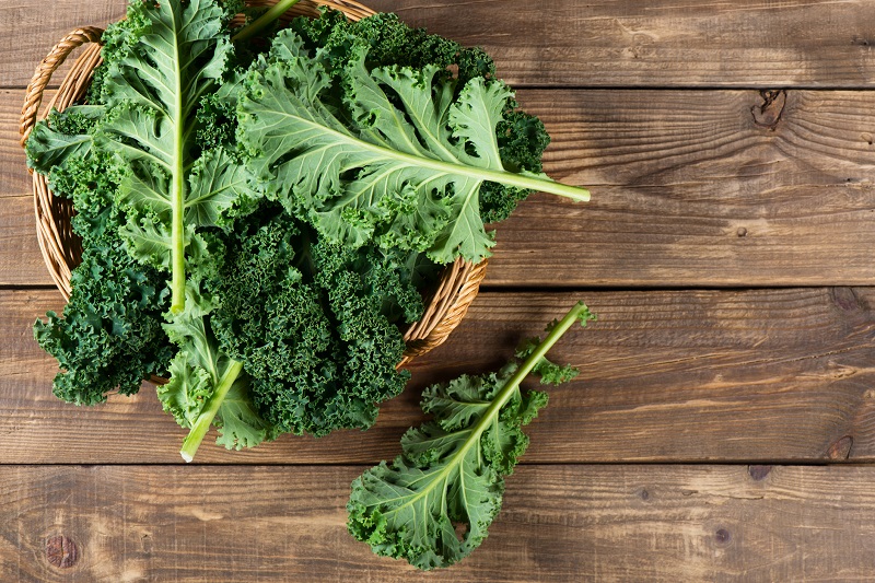 fresh kale in a wicker bowl