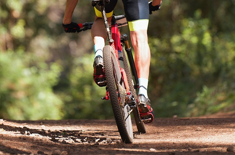 a close up of a man cycling on a dirt bike