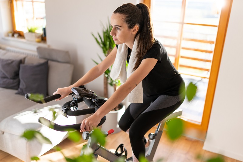 a woman exercising on her indoor cycling bike